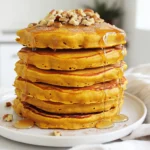 - 1 cup rolled oats - 1 cup canned pumpkin puree - 2 ripe bananas - 2 scoops vanilla protein powder - 1 teaspoon baking powder - 1 teaspoon cinnamon - 1/2 teaspoon nutmeg - 1/4 teaspoon salt - 1/2 cup almond milk (or any milk of choice) - 1 teaspoon vanilla extract - Coconut oil or butter for cooking - Maple syrup - Sliced bananas - Chopped nuts - Whipped cream To make my pumpkin protein pancakes, I gather these key ingredients. Each one plays a big role in taste and nutrition. The rolled oats serve as a great base. They add fiber and help bind the pancake. The canned pumpkin puree gives moisture and a rich flavor. It also packs a punch of vitamins. I use ripe bananas for sweetness. They blend smoothly into the batter. The vanilla protein powder boosts the protein content. This helps keep you full longer. Baking powder makes the pancakes fluffy. Cinnamon and nutmeg add warmth and spice. Salt enhances all the flavors. For the liquid, I use almond milk, but any milk works. The vanilla extract adds a nice touch of flavor. Finally, I like to use coconut oil or butter to cook the pancakes. It gives a nice crisp edge. Don't forget the toppings! Maple syrup, sliced bananas, and nuts add fun textures. Whipped cream makes it feel like a treat. You can mix and match to make it your own! To start, take 1 cup of rolled oats and blend them in a blender. You want to blend until they turn into a fine flour consistency. This oat flour gives the pancakes a nice texture. You can also use a food processor if you have one handy. Next, grab a large bowl. Add the oat flour, 1 cup of canned pumpkin puree, and 2 ripe bananas. Then, toss in 2 scoops of vanilla protein powder, 1 teaspoon of baking powder, 1 teaspoon of cinnamon, 1/2 teaspoon of nutmeg, and 1/4 teaspoon of salt. Pour in 1/2 cup of almond milk and 1 teaspoon of vanilla extract. Blend everything together until smooth. The batter should be thick but pourable. Now, it’s time to cook! Preheat a non-stick skillet over medium heat. Lightly grease the skillet with coconut oil or butter. Pour a ladleful of batter for each pancake onto the skillet. Cook for about 3-4 minutes until bubbles form on the surface. Flip the pancake and cook for another 2-3 minutes until golden brown. Repeat with the rest of the batter, adding more oil or butter as needed to prevent sticking. Serve warm and enjoy! To get the right batter, adjust the milk. If your batter is too thick, add more milk. You want it thick but pourable. This helps your pancakes cook evenly. For fluffy pancakes, blend the batter well. Air must mix in for fluffiness. Don't over-mix; this keeps them light. When flipping pancakes, wait for bubbles to form on the surface. This shows they are ready to flip. Use a thin spatula to lift them gently. To avoid sticking, make sure your skillet is greased. Use coconut oil or butter before cooking each pancake. This will create a nice, non-stick surface. For a lovely presentation, stack the pancakes high. Drizzle warm maple syrup over the top. Add sliced bananas and sprinkle with chopped nuts. A dash of cinnamon on top makes them look beautiful. You can even add whipped cream for extra fun! {{image_2}} To make vegan pumpkin protein pancakes, you need to swap a few items. First, replace the protein powder with a plant-based option. You can use pea protein or hemp protein. Next, choose a non-dairy milk, like almond or oat milk. These changes keep your pancakes tasty and nutritious while fitting a vegan diet. For gluten-free pumpkin protein pancakes, use gluten-free oats. Blend them just like regular oats to make oat flour. Check that your protein powder is gluten-free too. This way, you can enjoy fluffy pancakes without gluten. They will be just as delicious! Want to change things up? You can add chocolate chips for a sweet twist. Mix in a handful of dark chocolate chips into your batter before cooking. You can also try extra spices, like ginger or cloves, for a warm flavor. These little changes make your pancakes exciting and fun! To keep your leftover pancakes fresh, place them in an airtight container. This helps prevent them from drying out. You can also separate layers with parchment paper. Store them in the fridge for up to three days. To freeze pancakes, let them cool completely. Then, stack them with parchment paper in between. Place the stack in a freezer-safe bag or container. They can last up to three months in the freezer. For the best results, reheat pancakes in a toaster or on a skillet. If using a skillet, heat it over low heat. Add a little butter or oil to help them warm up. For a quick option, use a microwave for about 20-30 seconds. Enjoy your pancakes warm and fluffy! You can replace protein powder with other ingredients. Use Greek yogurt or nut butter. These will add protein and creaminess. You can also blend extra oats into the mix. This will help keep the pancakes thick and fluffy. Another option is to add ground flaxseed. It boosts nutrition and adds a nice texture. Yes, you can use fresh pumpkin. Start by roasting a pumpkin until soft. After cooling, scoop out the flesh and blend it until smooth. This homemade pumpkin puree tastes great and is fresh. Keep in mind, fresh puree might be a bit wetter. Adjust the almond milk in your recipe if needed. Pumpkin is full of nutrients. It has a good amount of protein and fiber. One cup of pumpkin has about 2 grams of protein. It also provides around 3 grams of fiber. Fiber helps with digestion and keeps you full. Plus, pumpkin is low in calories and high in vitamins. It’s a great choice for a healthy meal! These pumpkin protein pancakes are easy to make and delicious. We used oats, pumpkin, and bananas for a healthy base. You can mix in protein powder and spices for extra flavor. Optional toppings, like nuts or syrup, add a tasty touch. Feel free to experiment with variations, such as vegan or gluten-free options. Store extras in your fridge or freezer for a quick meal later. Enjoy making and sharing these pancakes. They’ll surely impress anyone who tries them!