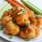 - 1 lb boneless, skinless chicken breasts, cut into bite-sized pieces - 1 cup breadcrumbs (preferably whole wheat for extra flavor) - 1/2 cup all-purpose flour - 2 large eggs - 1 teaspoon garlic powder - 1 teaspoon onion powder - 1/2 cup buffalo sauce (adjust for heat preference) - Salt and pepper to taste - Cooking spray - Air fryer - Shallow dishes for breading - Mixing bowl First, season the chicken pieces. In a bowl, mix 1 teaspoon of garlic powder, 1 teaspoon of onion powder, salt, and pepper. Add the bite-sized chicken pieces. Stir well to coat each piece evenly. This step adds flavor to every bite. Next, create a breading station. You need three shallow dishes. Put 1/2 cup of all-purpose flour in the first dish. In the second dish, beat 2 large eggs until smooth. Finally, place 1 cup of breadcrumbs in the third dish. Whole wheat breadcrumbs add extra flavor and crunch. Now, it’s time for the breading process. Start with the flour coating. Take a piece of chicken and dip it into the flour. Shake off any extra flour. This helps the egg stick better. Next, dip the floured chicken into the beaten eggs. Let the excess egg drip off. This step keeps the breading from getting soggy. Finally, apply the breadcrumbs. Place the chicken into the breadcrumbs and press gently. This ensures the crumbs stick well. Repeat this for all chicken pieces. Before cooking, preheat your air fryer. Set it to 400°F (200°C) and let it warm for about 5 minutes. Preheating helps the chicken cook evenly. Now, arrange the chicken in the basket. Spray the air fryer basket with cooking spray to prevent sticking. Place the breaded pieces in a single layer. Avoid overcrowding the basket. You may need to work in batches for the best results. Cook the chicken bites for 10-12 minutes. Flip them halfway through the cooking time. This helps them brown nicely. Check for an internal temperature of 165°F (74°C) to ensure they are fully cooked. Enjoy the crispy, spicy flavor of these buffalo chicken bites! To ensure even cooking, cut your chicken into uniform pieces. Aim for bite-sized chunks. This helps them cook at the same rate. Season all sides well with garlic powder, onion powder, salt, and pepper. The seasoning enhances flavor throughout each bite. For extra crunch, adjust your breading. Use whole wheat breadcrumbs for more texture. You can also double dip the chicken. After the first breading, dip it back in the egg and coat with breadcrumbs again. This gives a thicker, crunchier layer. Managing portion sizes is key. Do not crowd your air fryer basket. If you pile in too many chicken bites, they won’t cook evenly. Cook in batches if needed. This allows hot air to circulate around each piece. Preventing overcrowding keeps your bites crispy. Each batch should fit comfortably in the basket. Aim for a single layer. This makes sure each piece gets golden brown and tender. The best sauces for serving include ranch or blue cheese dressing. These creamy dips cool the heat of the buffalo sauce. You can also try a yogurt-based dip for a lighter option. For vegetable accompaniments, serve carrot and celery sticks. They add a nice crunch and freshness. These veggies balance the spicy flavor of the chicken bites. Enjoy your meal with these tasty sides! {{image_2}} You can easily change the heat of your buffalo chicken bites. If you want a milder flavor, use a mild buffalo sauce. For those who love spice, stick with a hotter version. You can also mix in different spices like paprika or cayenne pepper to boost the heat. Just remember, a little goes a long way! Adjusting the sauce not only changes the heat but also enhances the taste. If you need a gluten-free option, use crushed cornflakes instead of breadcrumbs. Cornflakes give a nice crunch and work well. You can also try panko breadcrumbs for a lighter texture. They add great crispiness too. Experimenting with different breadings can keep your chicken bites fresh and exciting. Mixing in cheese can take your chicken bites to the next level. Cheddar or mozzarella can melt beautifully inside. Adding herbs like parsley or oregano to the batter can also brighten the flavor. These little tweaks make each bite more delicious. Don't be afraid to get creative with your flavors! To keep your Air Fryer Buffalo Chicken Bites fresh, use airtight containers. These containers lock in moisture and flavor. They last up to three days in the fridge. After that, the bites may dry out or lose flavor. To maintain crispiness, use an oven for reheating. Preheat it to 350°F (175°C) and bake for about 10 minutes. This method helps the bites stay crunchy. If you use a microwave, they may become soft. For best results, stick to the oven. You can freeze both uncooked and cooked bites. For uncooked bites, freeze them on a baking sheet. Once frozen, transfer them to a bag. They can last up to three months. To freeze cooked bites, let them cool first. Then, store them in airtight bags. For thawing, place them in the fridge overnight for the best quality. This helps maintain taste and texture. Enjoy your tasty bites anytime! Yes, you can use frozen chicken. However, cooking frozen chicken needs some special care. First, make sure the chicken pieces are small enough to cook through. You may need to add extra cooking time, about 5-10 minutes. Always check if they are cooked well. The key is to ensure they reach an internal temperature of 165°F (74°C). This way, you keep them safe and tasty. Most air fryers work well for buffalo chicken bites. I recommend models with a basket style. Brands like Ninja, Philips, and Cosori are great choices. Look for features such as adjustable temperature settings and a timer. These features help you get perfect results each time you cook. Absolutely! While buffalo sauce is a classic, you can try other sauces. BBQ sauce offers a sweet twist. Ranch dressing gives a creamy flavor. For a tangy kick, try teriyaki or sriracha. Feel free to mix and match to find your favorite taste! To check if the chicken is fully cooked, use a meat thermometer. Insert it into the thickest piece of chicken. It should read 165°F (74°C). This temperature ensures the chicken is safe to eat. If you don't have a thermometer, cut into a piece. The meat should be white and juices should run clear. You now know how to make tasty air fryer buffalo chicken bites. We discussed the main ingredients, like chicken and breadcrumbs, and the spices that add flavor. I shared step-by-step instructions from prep to cooking. Plus, you learned tips for getting that perfect crunch. Don’t forget about the variations and storage tips to keep your bites fresh. With all this knowledge, you can enjoy these bites any time. Dive in and start cooking!