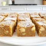 - 1 cup apple butter - 1 cup brown sugar, packed - 1/2 cup unsalted butter, melted - 1/4 cup granulated sugar - 2 large eggs - 1 teaspoon vanilla extract - 2 cups all-purpose flour - 1 teaspoon baking powder - 1/2 teaspoon baking soda - 1/4 teaspoon salt - 1 teaspoon ground cinnamon - Optional ingredients: 1/2 cup chopped walnuts, 1/2 cup white chocolate chips To make apple butter blondies, gather the ingredients first. Apple butter is the star here. It brings rich flavor and moisture. The brown sugar adds sweetness and depth. Unsalted butter makes the batter creamy. Granulated sugar gives a nice lift to the blondies. Two eggs add structure. Vanilla extract enhances the taste. All-purpose flour forms the base. Baking powder and baking soda help the blondies rise. Salt balances the sweetness, while ground cinnamon adds warmth. Feel free to personalize your blondies. You can fold in chopped walnuts for crunch. Or mix in white chocolate chips for extra sweetness. These ingredients make your blondies even more delightful. 1. Preheat your oven to 350°F (175°C). This helps the blondies bake evenly. 2. Grease a 9x13 inch baking pan. You can also line it with parchment paper. This makes it easy to remove the blondies later. 1. In a large bowl, whisk the melted butter, brown sugar, and granulated sugar together. Mix until smooth. 2. Add the apple butter, eggs, and vanilla extract. Stir until well combined. 3. In another bowl, sift together the flour, baking powder, baking soda, salt, and ground cinnamon. 4. Gradually add the dry mix to the wet mix. Stir just until combined. Do not overmix! 5. If you want extra crunch, fold in chopped walnuts and white chocolate chips. 1. Pour the batter into the prepared baking pan. Spread it evenly across the pan. 2. Bake in the preheated oven for 25-30 minutes. To check doneness, insert a toothpick into the center. It should come out clean. 3. Once baked, let the blondies cool in the pan for about 10 minutes. Then, transfer them to a wire rack to cool completely before cutting into squares. To make the best apple butter blondies, avoid overmixing the batter. When you mix too much, it can make them tough. Stir just until you see no dry flour. This way, they'll stay soft and chewy. Baking time is key for perfect blondies. Check them at 25 minutes. Insert a toothpick in the center. If it comes out clean, they are ready. If it has wet batter, give them a few more minutes. Serving your blondies nicely makes them even more enjoyable. Try placing them on a rustic wooden board. You can also use a decorative plate. Dust them with powdered sugar for a lovely touch. For extra flair, drizzle caramel sauce over the top. It adds sweetness and looks great. You can also serve them with a scoop of vanilla ice cream for a fun treat. Sometimes, blondies can have issues. If they turn out too dry, you might have baked them too long. Keep an eye on them as they bake. If they are too gooey in the center, they need more time in the oven. Just check again in a few minutes. If you added walnuts, ensure they are chopped small for even texture. Finally, if they stick to the pan, make sure to grease it well or line it with parchment. This helps with easy removal and keeps them intact. {{image_2}} You can change the flavor of your apple butter blondies. Try using different nut butters. Almond or cashew butter adds a unique taste. It also gives a nice twist to the recipe. You can also add spices for a new flavor profile. Nutmeg or ginger adds warmth and depth. A pinch of cardamom will surprise your taste buds. Experiment to find your favorite mix! If you need gluten-free blondies, use gluten-free flour. Almond flour or oat flour works well. These flours keep the blondies soft and tasty. For vegan blondies, replace the eggs with applesauce. You can also use flaxseed meal mixed with water. It acts like an egg and binds the batter well. Use a plant-based butter to replace regular butter for a full vegan treat. You can easily swap out white chocolate chips. Dark chocolate or butterscotch chips add a richer flavor. If you want something nutty, try using different nuts. Pecans or hazelnuts work great instead of walnuts. This way, you can tailor each batch to your taste. Adjust the ingredients to make each blondie special! To keep your apple butter blondies fresh, store them in an airtight container. This helps maintain moisture and flavor. You can leave them at room temperature for up to three days. If you want to keep them longer, place them in the fridge. They will stay good for about a week. You can freeze your blondies for future treats. First, let them cool completely. Then, cut them into squares. Wrap each square in plastic wrap. Place the wrapped squares in a freezer bag. They will last for up to three months in the freezer. When you're ready to enjoy them, take out a square. Let it thaw at room temperature for about an hour. If you want them warm, pop them in the microwave for 10-15 seconds. Enjoy your tasty treat! What is the difference between blondies and brownies? Blondies and brownies share a similar base but differ in flavor and color. Brownies use cocoa powder, which gives them a dark chocolate taste. Blondies skip the cocoa and use brown sugar and vanilla, offering a rich, sweet flavor. They are often lighter in color, resembling a cookie bar more than a brownie. Can I make this recipe without eggs? Yes, you can make this recipe without eggs! To replace each egg, use 1/4 cup of unsweetened applesauce or a mashed banana. These swaps keep the blondies moist and help bind the ingredients together. How can I tell when my blondies are done? Check for doneness by inserting a toothpick into the center. If it comes out clean or with a few moist crumbs, your blondies are ready. They should be set around the edges but slightly soft in the center. Can I use homemade apple butter? Absolutely! Using homemade apple butter adds a personal touch and unique flavor. Just ensure it's smooth and not too watery, as this can affect the batter's texture. How do I adjust baking time for a smaller pan? If you use a smaller pan, your blondies may bake faster. Start checking for doneness 5-10 minutes earlier. Always use the toothpick test to ensure they are baked just right. You learned all about making delicious blondies. We covered key ingredients like apple butter and sugar, plus steps to mix and bake. We discussed tips to perfect your blondies and presented fun variations for any diet. Remember, the right storage keeps them fresh. Now, it’s time for you to create your own tasty treats! Enjoy the process and share with others.