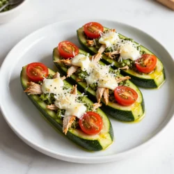 - Zucchinis: You will need 4 medium zucchinis for this recipe. They serve as the boats. - Cooked chicken: Use 1 cup of shredded cooked chicken. This adds protein and flavor. - Basil pesto: A 1/2 cup of basil pesto brings a rich taste. It is the star of the dish. - Cherry tomatoes: Get 1 cup of halved cherry tomatoes. They add juiciness and color. - Cheeses: Use 1/2 cup of shredded mozzarella and 1/4 cup of grated Parmesan cheese. They melt beautifully. - Seasonings: You will need salt, pepper, and 1 teaspoon of garlic powder for flavor. - Olive oil: One tablespoon of olive oil helps to keep the zucchini moist. - Optional garnishes: Fresh basil leaves can be used for a pop of color and taste. These ingredients mix together well. They create a tasty and healthy meal that is easy to prepare. I enjoy the balance of flavors and textures in this dish. The zucchini provides a nice crunch while the filling is creamy and savory. {{ingredient_image_1}} - Preheat your oven to 375°F (190°C). - Wash the zucchinis and slice them in half lengthwise. Use a spoon to scoop out some flesh, leaving a 1/4-inch border. This creates the perfect boat shape for filling. - In a medium bowl, mix 1 cup of shredded chicken, 1/2 cup of basil pesto, and 1 cup of halved cherry tomatoes. - Add 1 teaspoon of garlic powder, and season with salt and pepper to taste. Stir the mixture well to combine. - Drizzle the zucchini halves with 1 tablespoon of olive oil. Lightly season them with salt and pepper. - Place the zucchini on a baking sheet, cut side up. Fill each zucchini boat evenly with the pesto chicken mixture. - Top with 1/2 cup of shredded mozzarella cheese and 1/4 cup of grated Parmesan cheese. - Bake the zucchini boats in the preheated oven for about 25-30 minutes. - Look for the zucchini to be tender and the cheese to be bubbly and golden. Enjoy the wonderful aroma as they cook! To get soft zucchini, cook them just right. For larger zucchinis, you may need to bake them longer. Start with 30 minutes and check for doneness. Use a fork to see if they feel soft. They should not be mushy but tender enough to eat. Want more taste? Add spices like red pepper flakes or Italian herbs. You can also mix in chopped spinach or bell peppers for extra veggies. These additions add depth and keep it fresh. Pair these zucchini boats with a light salad or crusty bread. A side of roasted veggies or quinoa also works well. This way, you have a complete meal that is tasty and colorful. Pro Tips Choose Firm Zucchini: Select zucchinis that are firm and uniform in size to ensure even cooking and a sturdy base for your filling. Customize the Filling: Feel free to add other ingredients like spinach, artichokes, or bell peppers to the chicken mixture for added flavor and nutrition. Use Fresh Pesto: If possible, use fresh basil pesto for a brighter flavor. Homemade pesto can elevate the dish significantly. Check for Doneness: Keep an eye on the zucchini while baking; they should be tender but not mushy. Adjust cooking time as necessary based on your oven. {{image_2}} You can make a meatless version of pesto chicken zucchini boats easily. Instead of chicken, use a mix of sautéed mushrooms and spinach. You can also add some chickpeas for protein. This will keep the dish hearty and satisfying. Just follow the same steps for the filling. Mix the veggies with pesto, garlic powder, salt, and pepper. You have many choices for proteins in this recipe. Try ground turkey or shredded tofu for a lighter option. Beans are also a great choice; black beans or white beans work well. These choices add flavor and fit into different diets. Simply replace the chicken with your choice of protein and mix with pesto. If you need to avoid dairy, there are great cheese options. Look for vegan cheese that melts well. Nutritional yeast is another tasty choice; it adds a cheesy flavor and is dairy-free. You can also try cashew cheese for a creamy texture. Be sure to check the labels for any dietary restrictions. To keep your pesto chicken zucchini boats fresh, store them in an airtight container. Make sure they cool down before sealing the lid. This will help prevent moisture build-up inside. Place the container in the fridge. They should stay fresh for up to three days. You can also wrap them tightly in plastic wrap if you prefer. If you want to freeze your zucchini boats, let them cool completely first. Next, wrap each boat in plastic wrap. Then, place the wrapped boats in a freezer bag. Make sure to remove as much air as possible. They can last in the freezer for about two months. When you want to eat them, thaw in the fridge overnight. Reheat in the oven at 375°F (190°C) until heated through. Pesto chicken zucchini boats last in the fridge for about three days. In the freezer, they can last for two months. Always check for any off smells or changes in color before eating leftovers. If they look or smell bad, it’s best to throw them out. No, you should not use raw chicken. Cooked chicken saves time and ensures safety. Raw chicken needs more cooking time. It may not cook fully in the zucchini boats. Always use cooked chicken for best results. To make this dish gluten-free, use gluten-free pesto. Check the label to ensure it has no gluten. All other ingredients are naturally gluten-free. You can enjoy this meal without worry. Great side dishes include a fresh salad or garlic bread. A simple green salad adds crispness. Garlic bread offers a nice toast to the meal. You can also try steamed veggies for a healthy touch. Yes, you can prepare these boats ahead. Assemble them and store in the fridge. Bake them right before serving. This makes for a quick meal when you are busy. This blog post covered all you need to know about making delicious zucchini boats. We discussed the best ingredients, step-by-step directions, and even offered tips for perfect results. Don't forget the variations for different diets and how to store your leftovers. These tasty boats are easy and fun to make. You can enjoy them with friends or store some for later. Dive in and try this recipe—it's sure to impress!